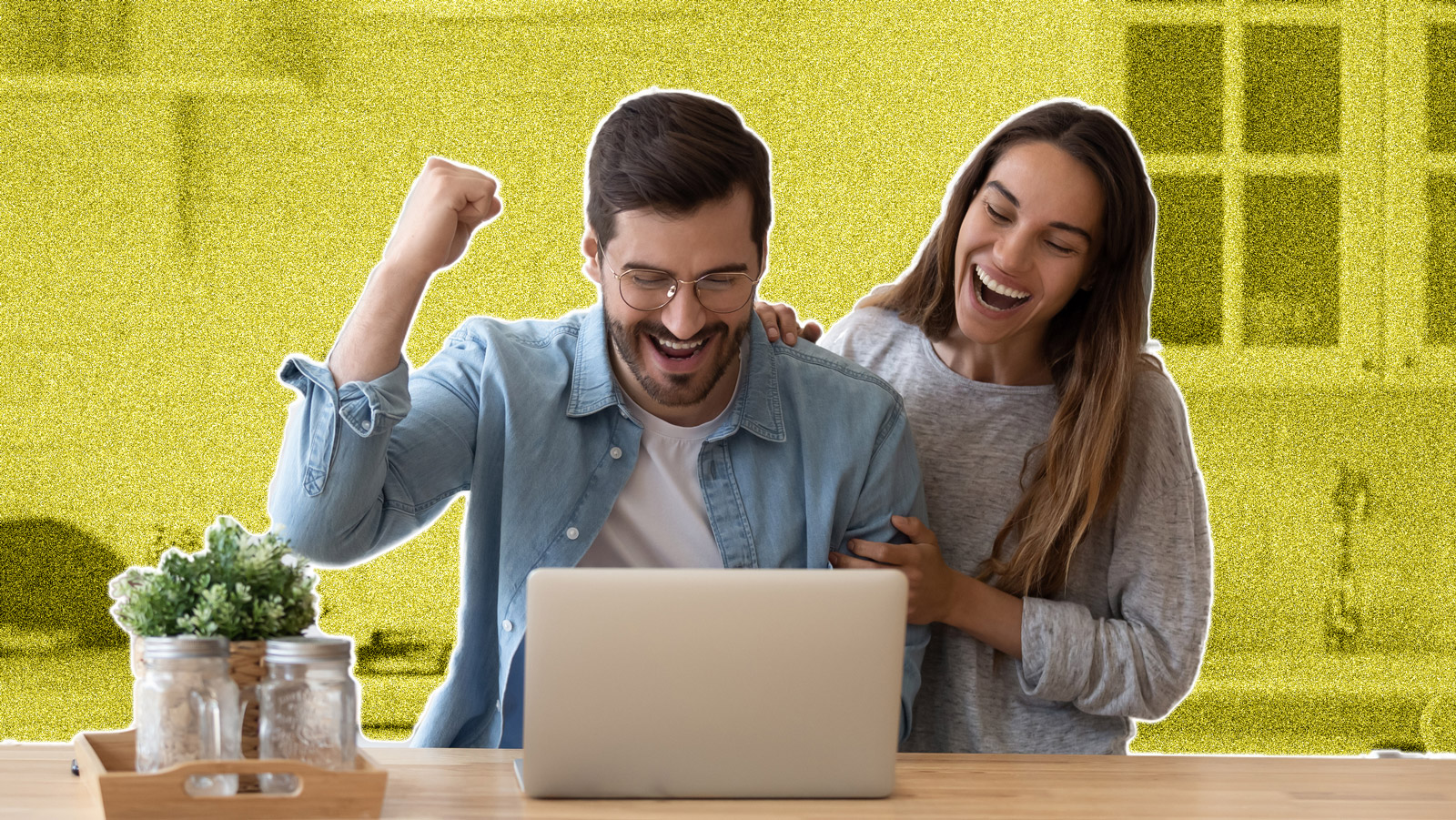 Young couple looking excited at a laptop
