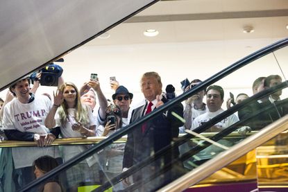Donald Trump rides an escalator