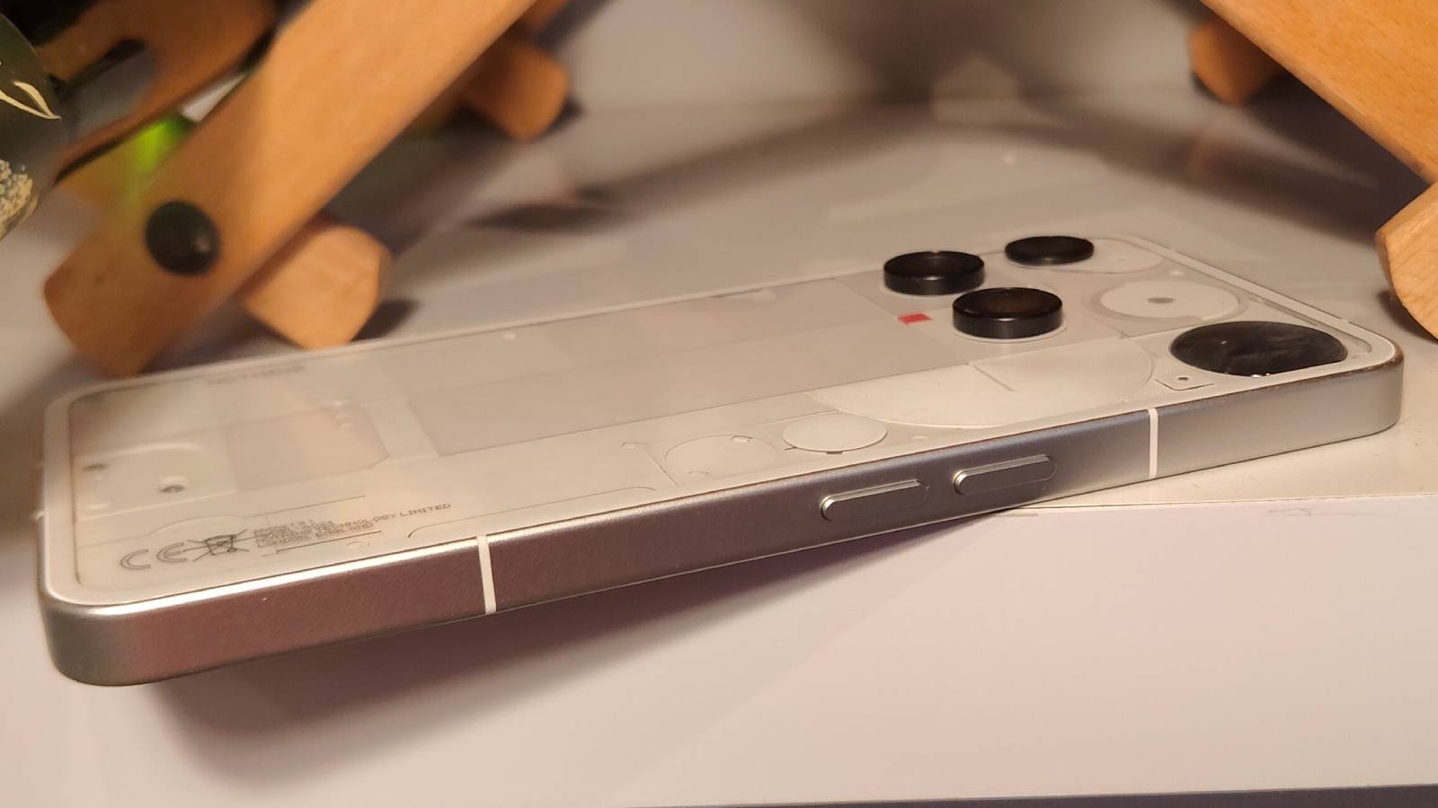 The Nothing Phone 3 laid down, showing its volume rocker.