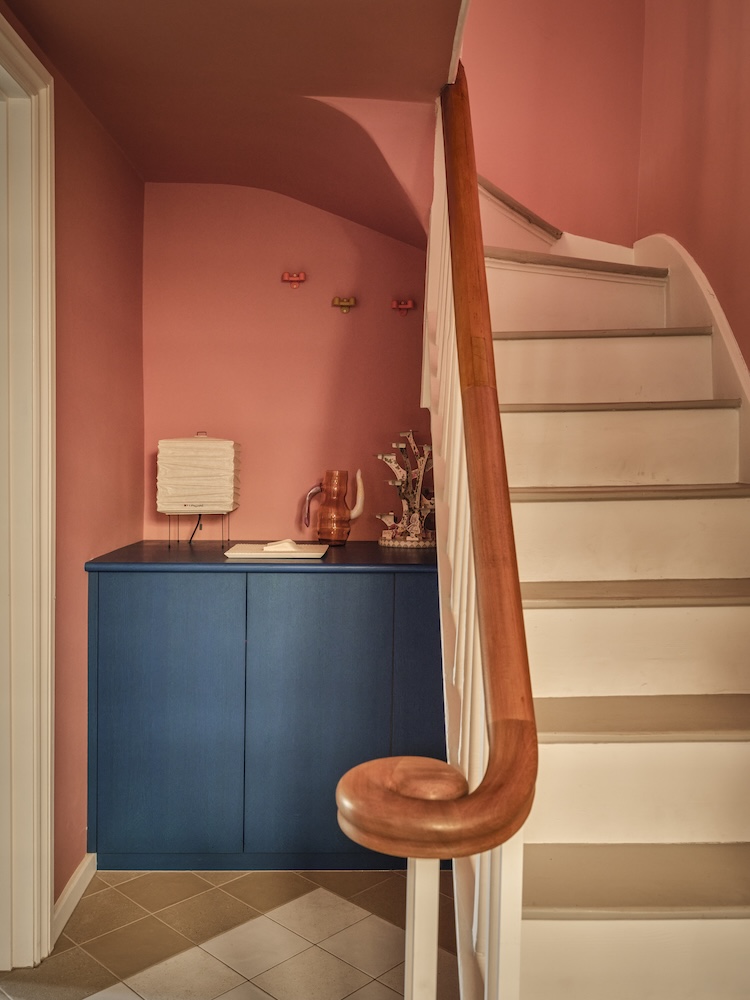 A hallway painted in a rose-inspired shade.