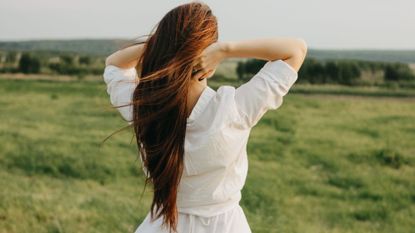 Best Shampoo and conditioner for dry hair - woman stood in the countryside with flowing hair 