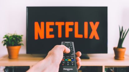 Netflix logo shown on TV with remote control being pointed at the screen