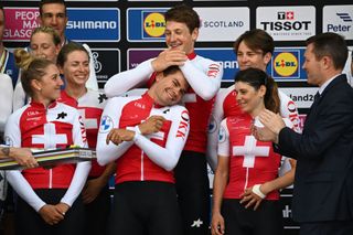 The Swiss squad celebrate their Worlds mixed relay team time trial success on the podium in Glasgow