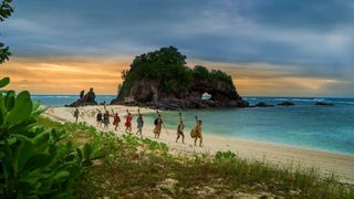 Contestants walking on the beach on Survivor season 47