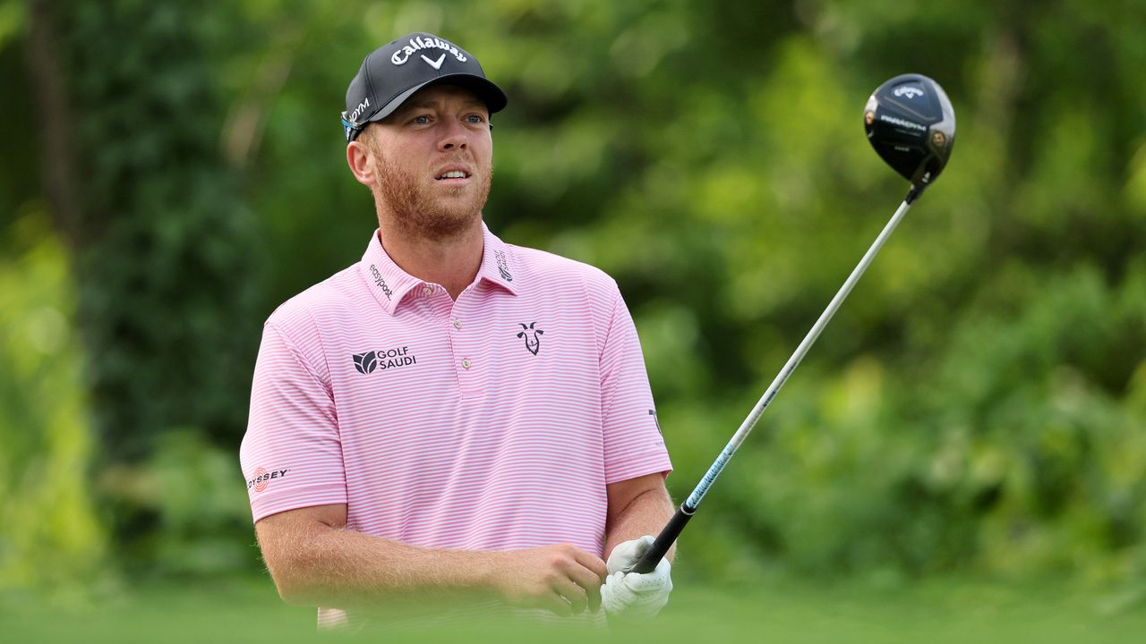 Talor Gooch wearing pink shirt lining up a drive