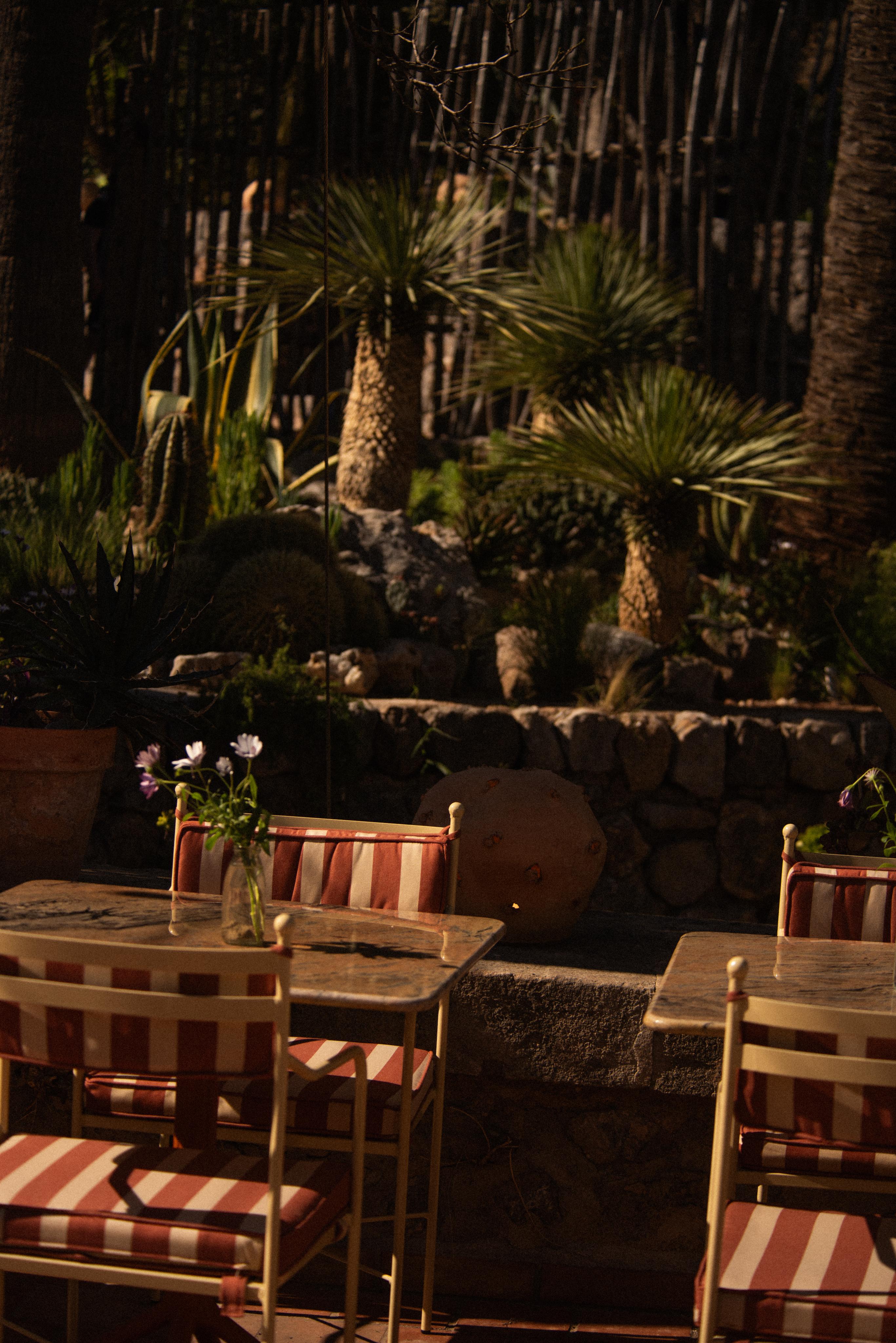 upholstered seating, tables and steel frame chairs on sunny terrace restaurant