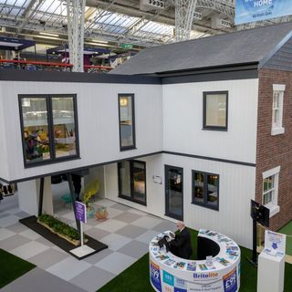 white house with grey windows and artificial grass
