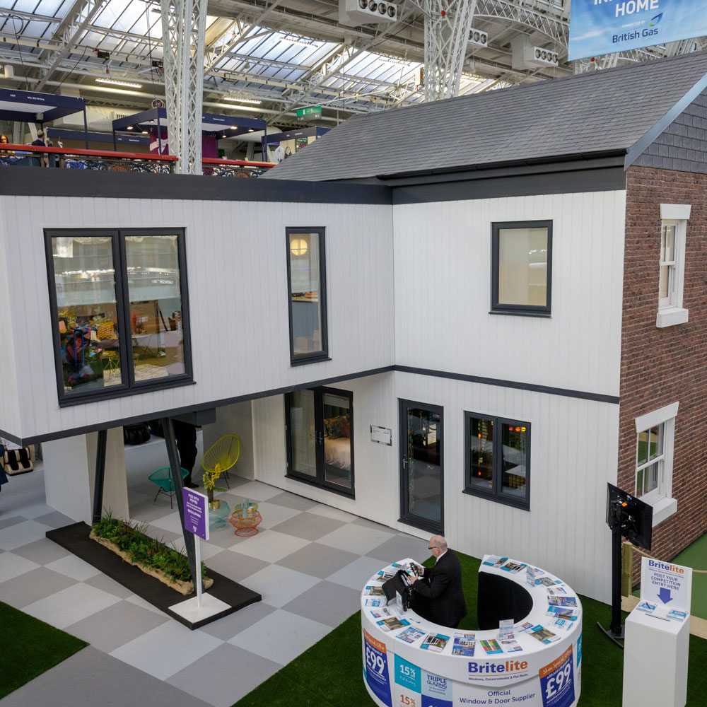 white house with grey windows and artificial grass