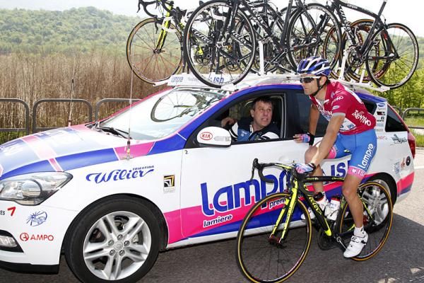 Race leader Michele Scarponi has a chat at the team car.