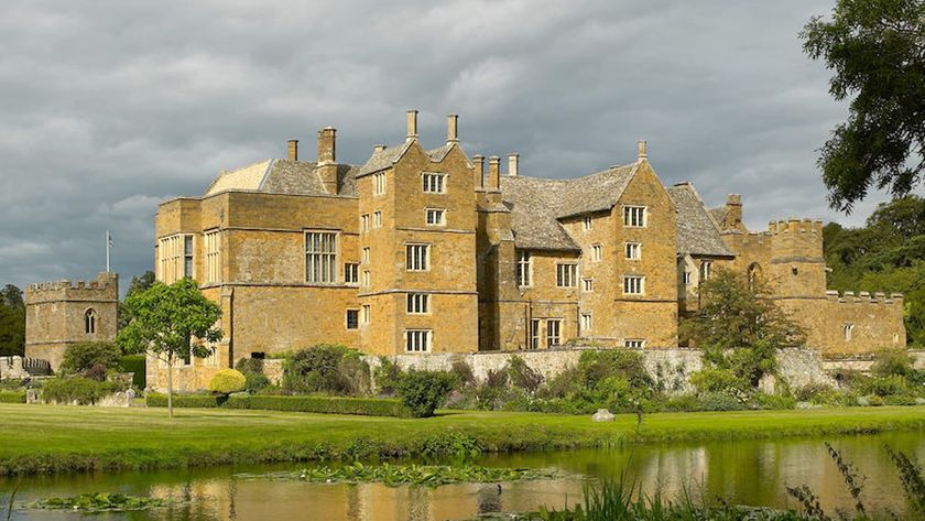 A castle with a moat with a stone structure