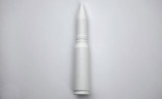 Model of a 14.5 x 114mm MDZ high explosive shell in white, photographed against a grey background