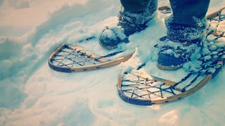 An old pair of wooden snowshoes in the snow