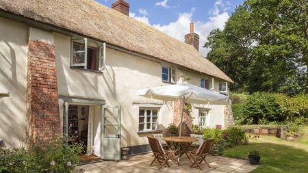 outdoor dining area thatched cottage