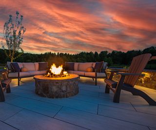 curved patio with central fire pit and Adirondack chairs