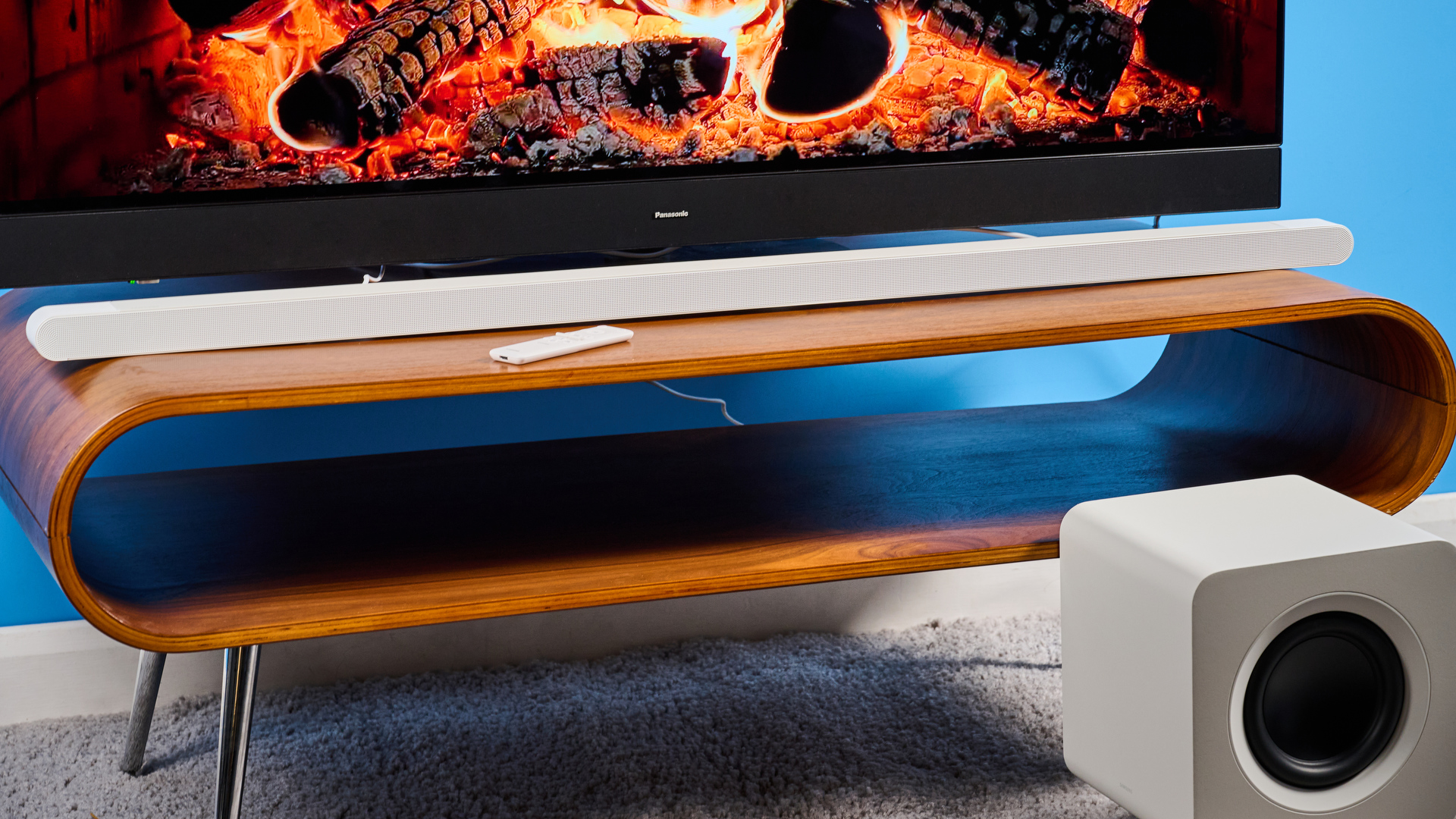 the samsung hw-s801d soundbar and subwoofer in white, an ultra slim soundbar with on-bar buttons, a remote, and separate subwoofer with a black cone