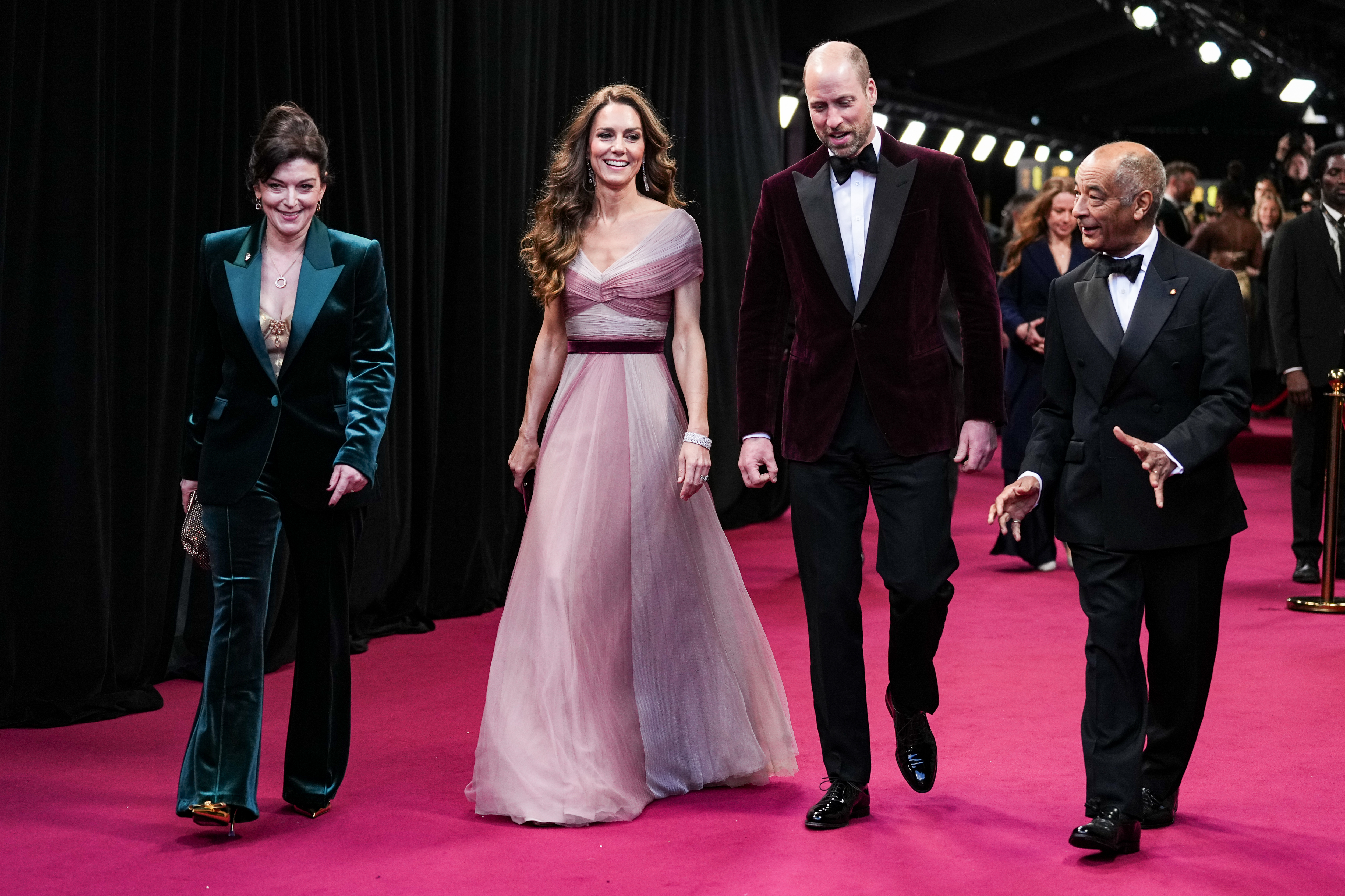 Princess Kate wearing a pink gown on the BAFTA red carpet with Prince William