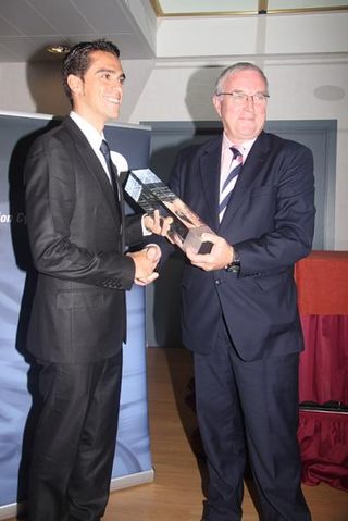 Alberto Contador is presented with the trophy for top rider in the 2009 World Rankings by UCI president Pat McQuaid.