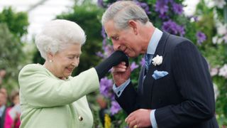 Queen Elizabeth II presents Prince Charles, Prince of Wales with the Royal Horticultural Society's Victoria Medal of Honour during a visit to the Chelsea Flower Show on May 18, 2009 in London.