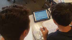 Eighth graders at Sossaman Middle School compare heating and cooling curves for two liquids using a wireless PASCO temperature sensor and an iPad.  