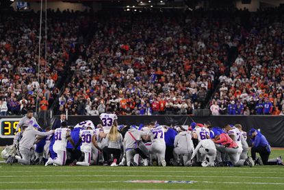 Bills players pray following an injury to teammate Damar Hamlin. 