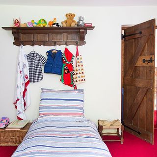 children bedroom with bedlinen peg rail and shelving unit