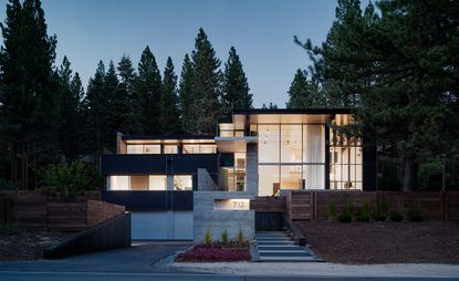 The house's front façade, a framework of steel and glass, faces the shores of Lake Tahoe in Nevada