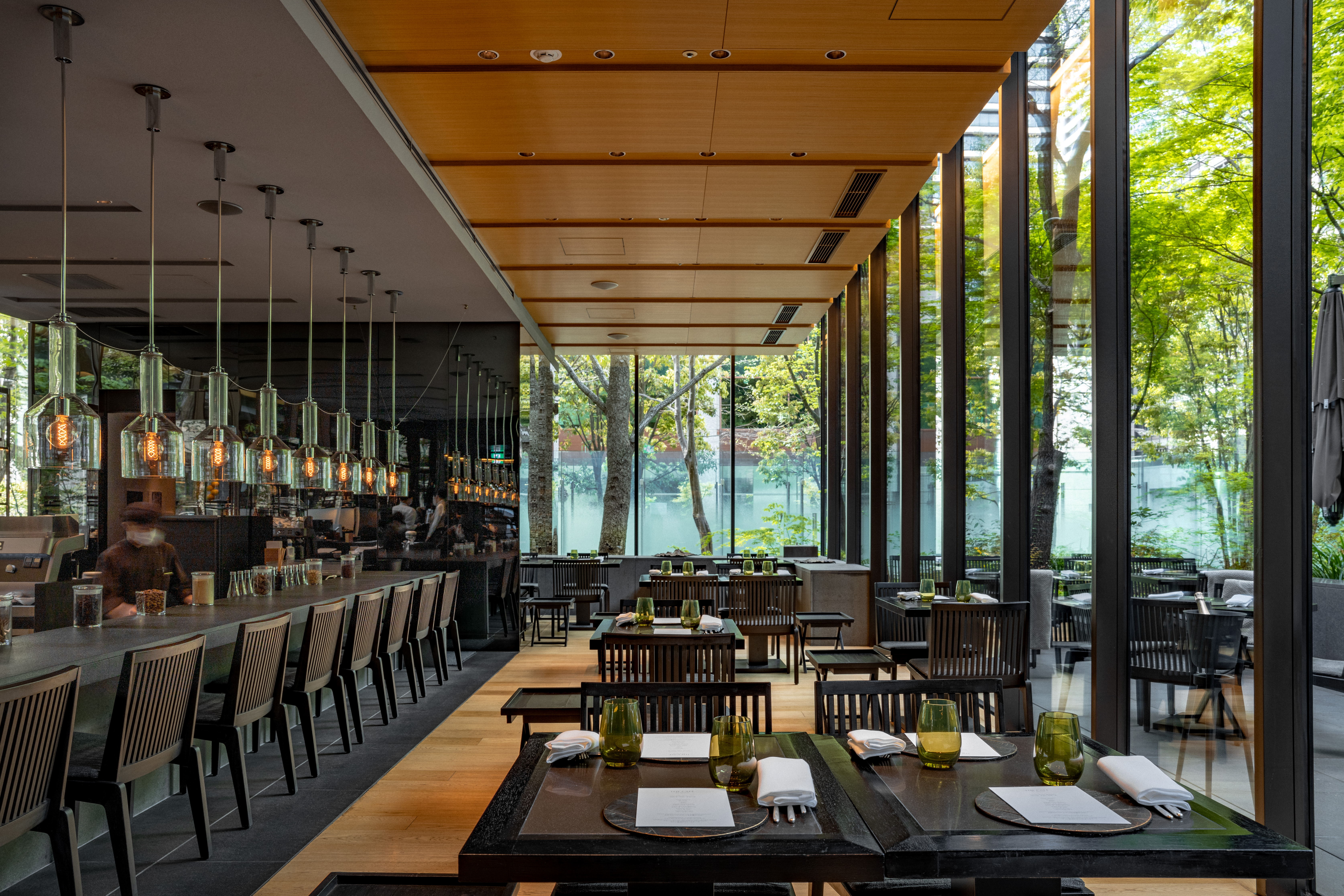 view of a serene hotel in tokyo, adorned with wooden furnishing, washi paper and natural stone touches