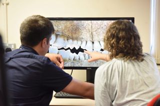 Bethan Upex and Kamal Badreshany, both from the Department of Archaeology at Durham University in England, study the remains of a Scottish soldier using 3D photography.