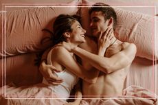 A man and a woman embracing in bed