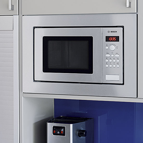 blue and grey kitchen with workspace and microwave