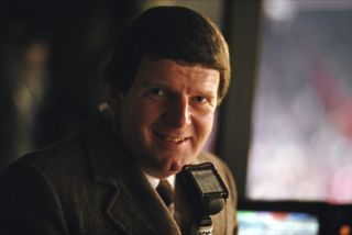 Commentator John Motson, pictured holding his microphone, 1985