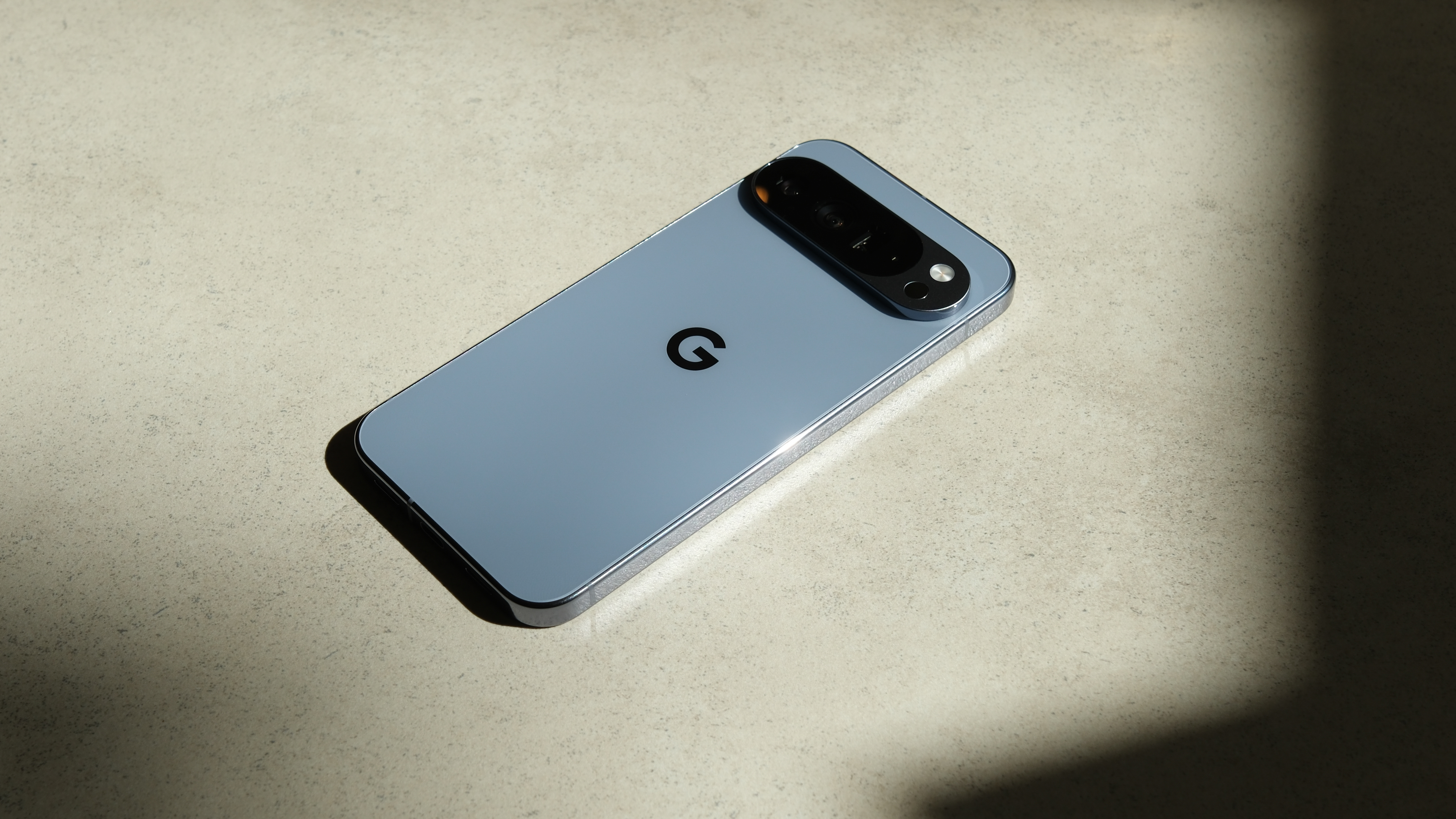 Google Pixel 10 Pro XL on a marble surface in the sun