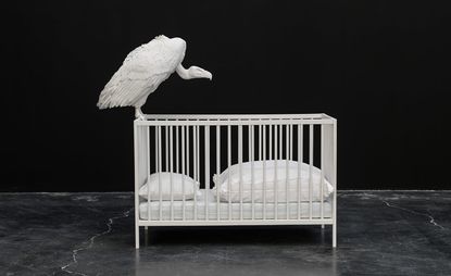 white vulture on cradle artwork