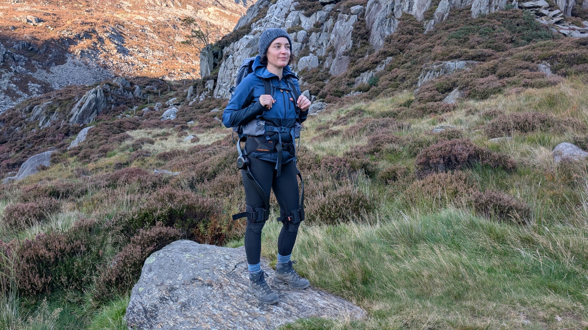 Julia Clarke hiking up Ben Nevis with a Hypershell X ultra on a sunny day