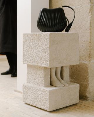 A plinth in the Lemaire boutique with a handbag on top