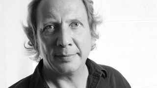 A black and white portrait of Dave Burrluck
