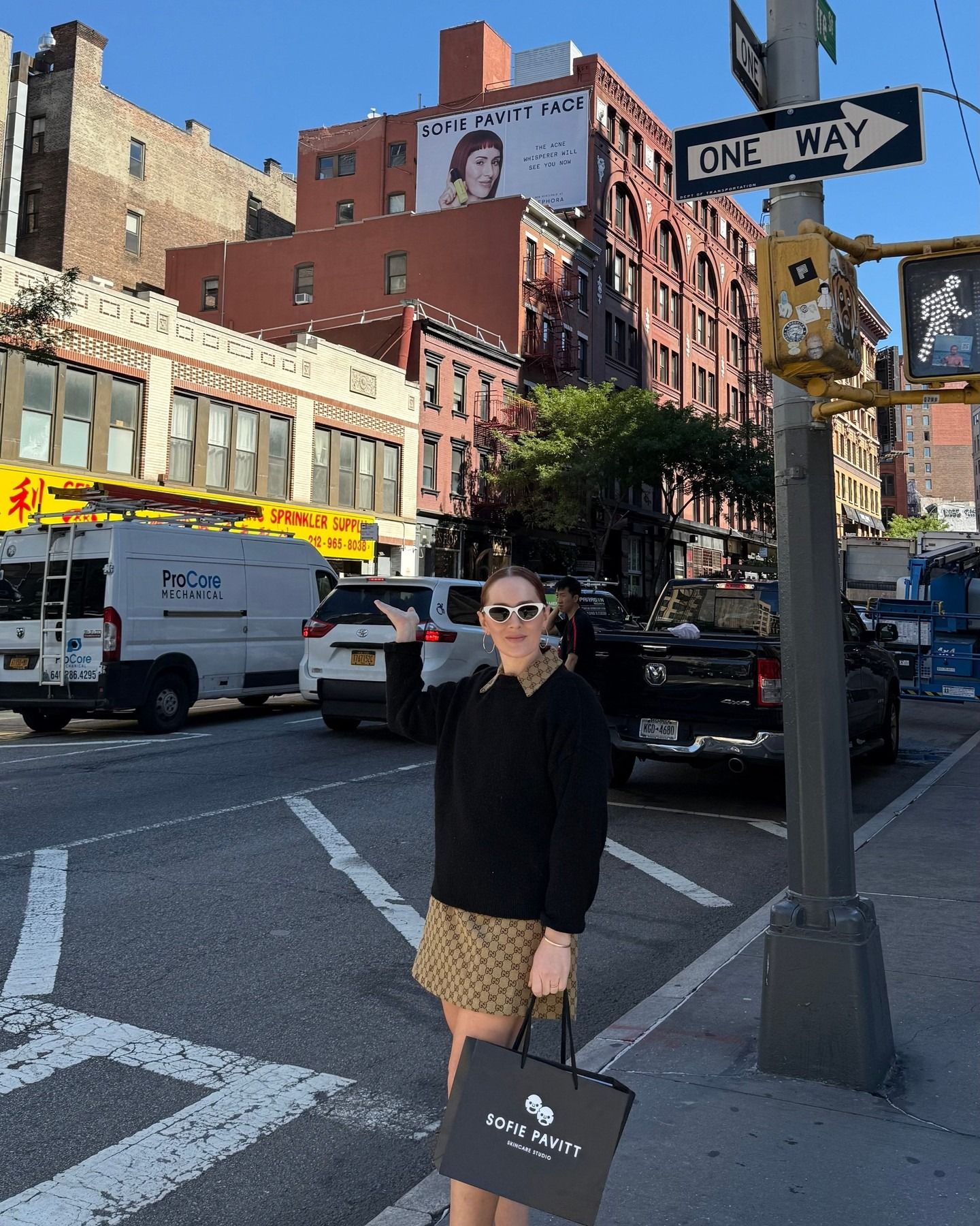 Photo of Sofie Pavitt in NYC next to her billboard