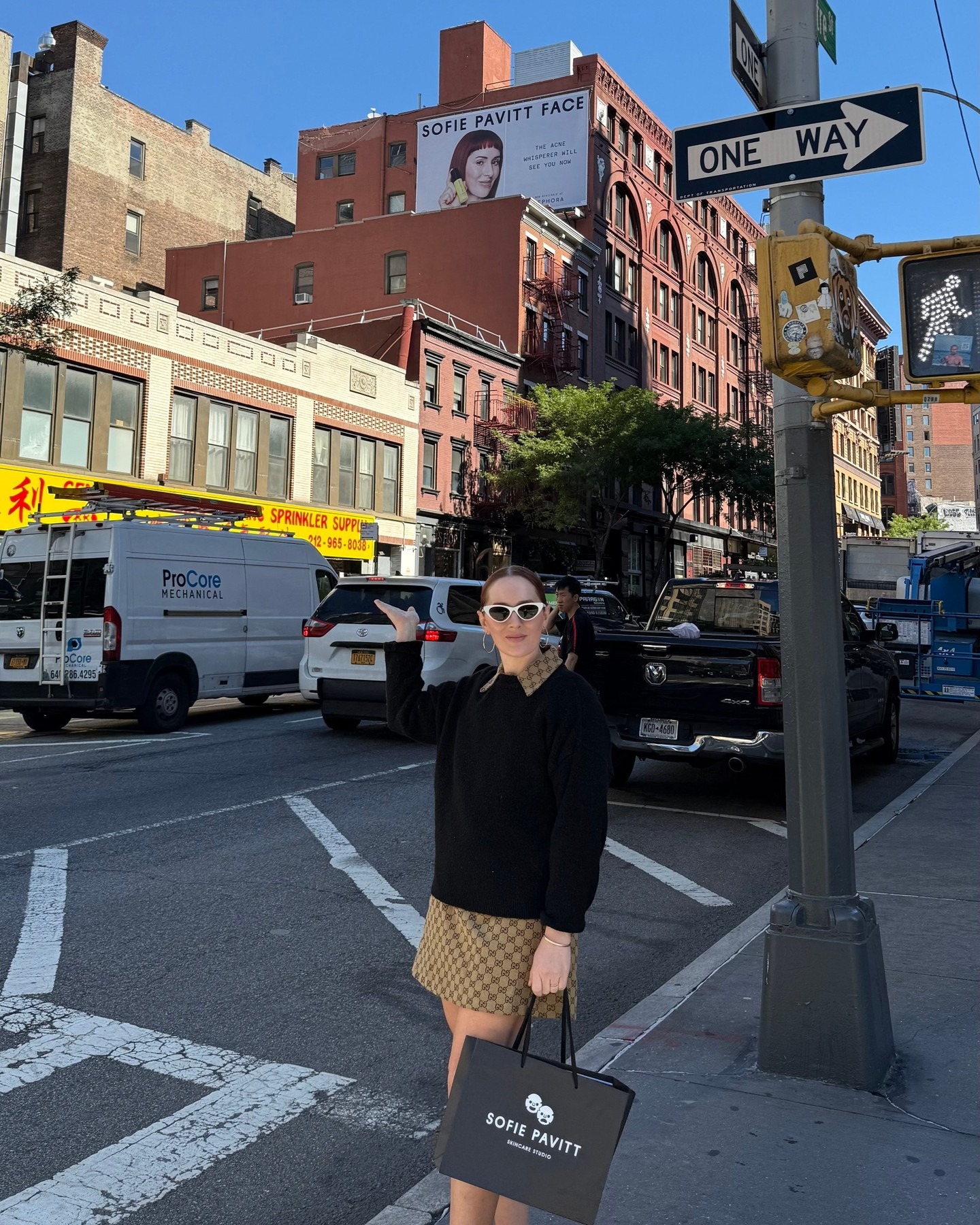 Photo of Sofie Pavitt in NYC next to her billboard