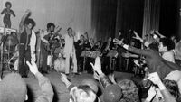 American soul singer and songwriter James Brown (1933-2006) performs live on stage with the J.B.'s, including bass guitarist Bootsy Collins and singer Bobby Byrd (1934-2007) behind, in East Ham, London in March 1971. 