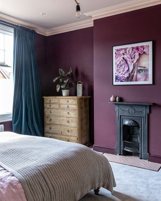 A bedroom with purple walls and lilac ceiling