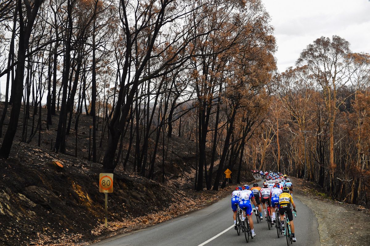 Riders pass through an area badly affected by the bushfires on stage 3 of the 2020 Tour Down Under between Unley and Paracombe