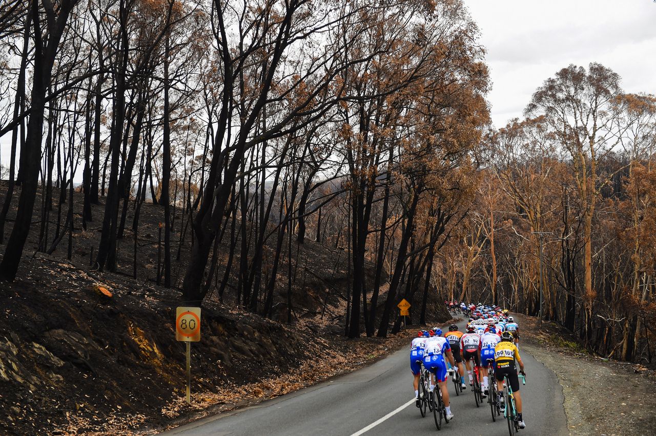 Riders pass through an area badly affected by the bushfires on stage 3 of the 2020 Tour Down Under between Unley and Paracombe