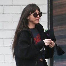 Dakota Johnson wearing sweatpants over leggings