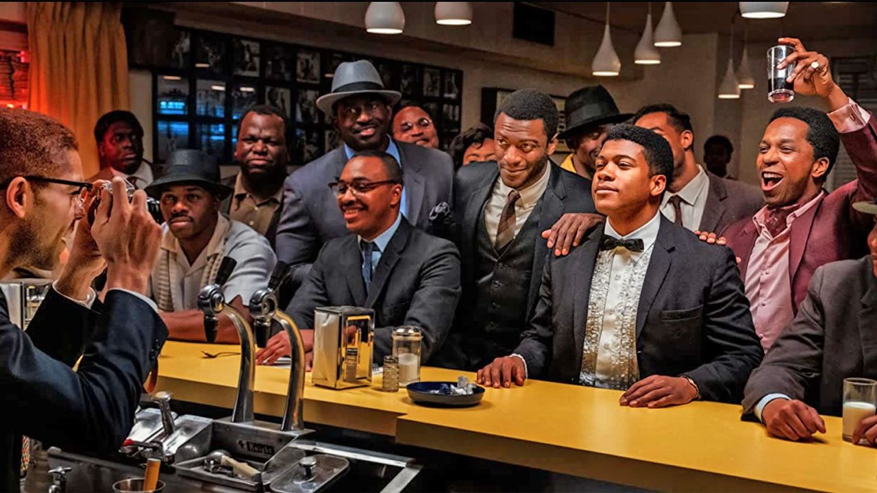 Regina King&#039;s film ONE NIGHT IN MIAMI 2020 Amazon Studios film. From right: Leslie Odom Jr, Eli Goree and Aldis Hodge with Kingsley Ben-Adir as Malcolm X taking a photo of the group