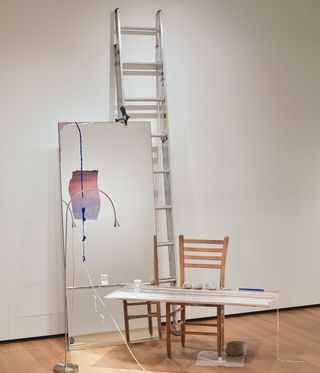 Ladders a chair and some art