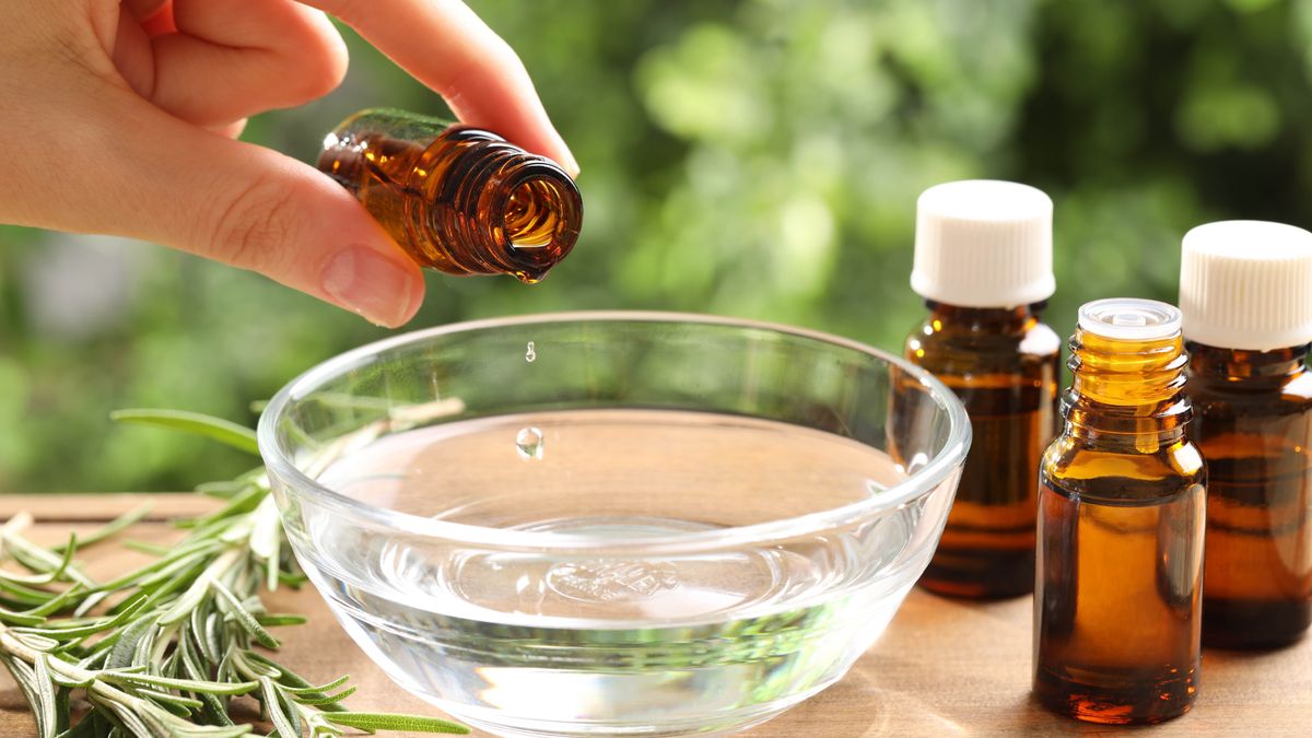 Putting essential oil in bowl of water