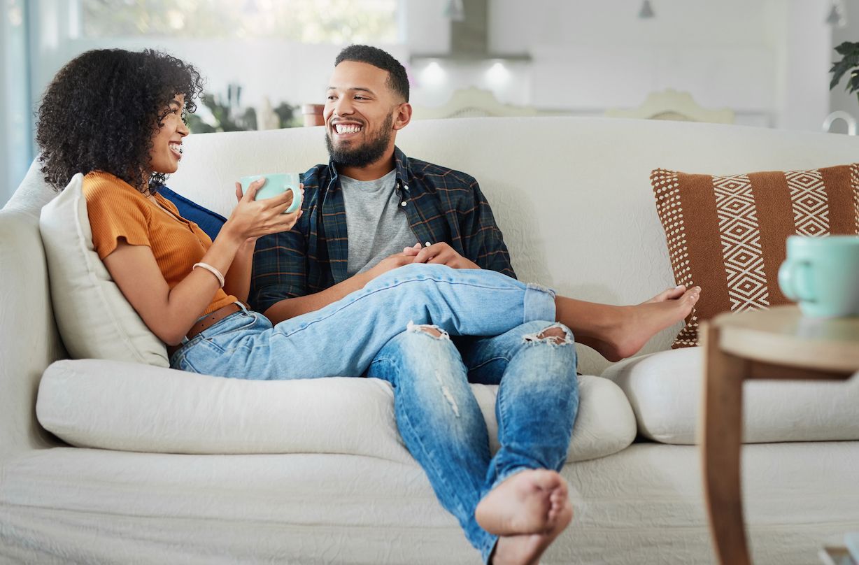 mixed race woman and partner on sofa