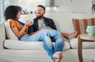 mixed race woman and partner on sofa