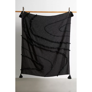 black blanket with tufted swirl design