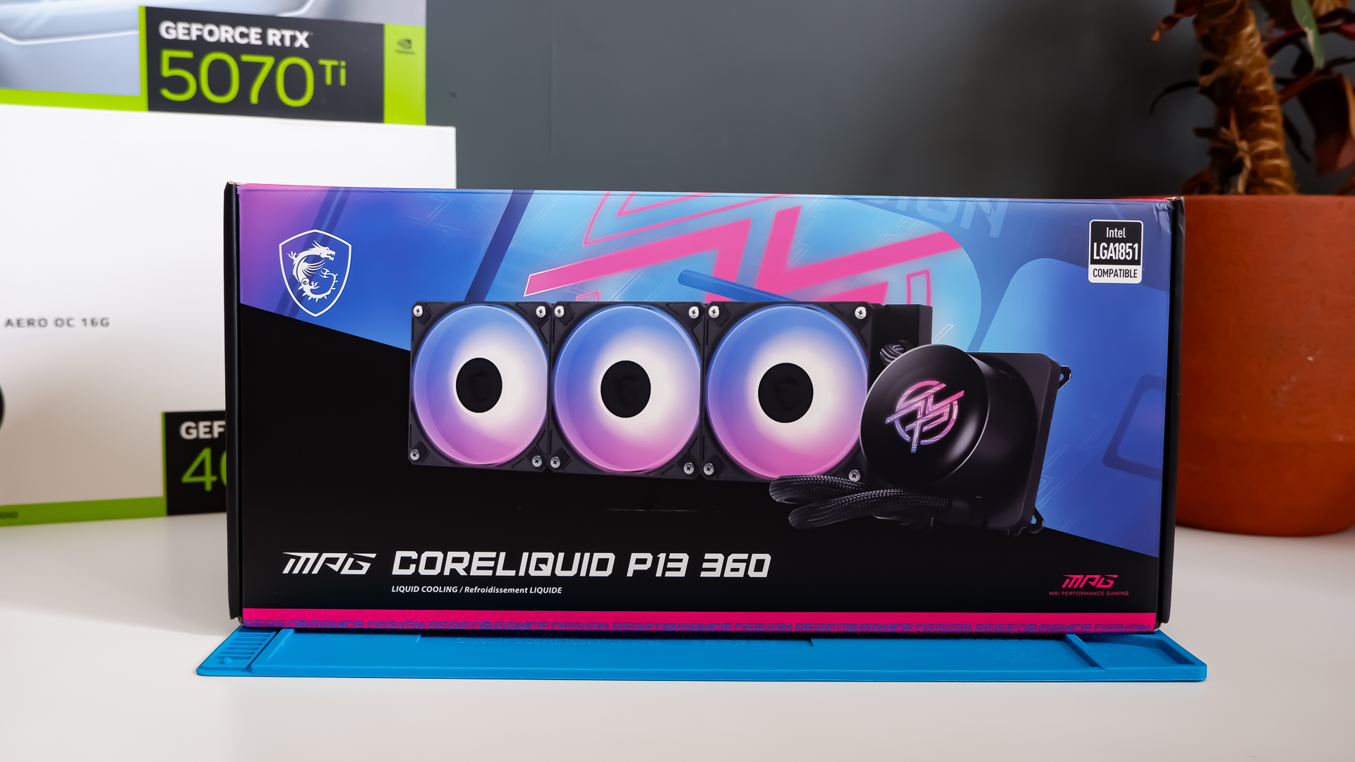 An MSI MPG CoreLiquid P13 all-in-one liquid cooler on a desk and installed onto a test bench for testing.